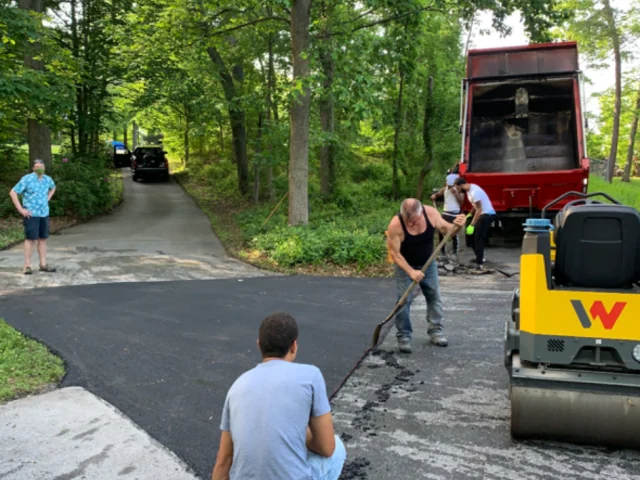 South State Paving crew finishing the edges of a new driveway