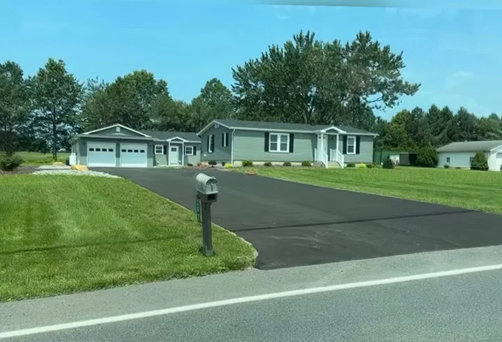 Fresh driveway and parking pad at a rancher, green lawn, South State Paving, Southern Maryland