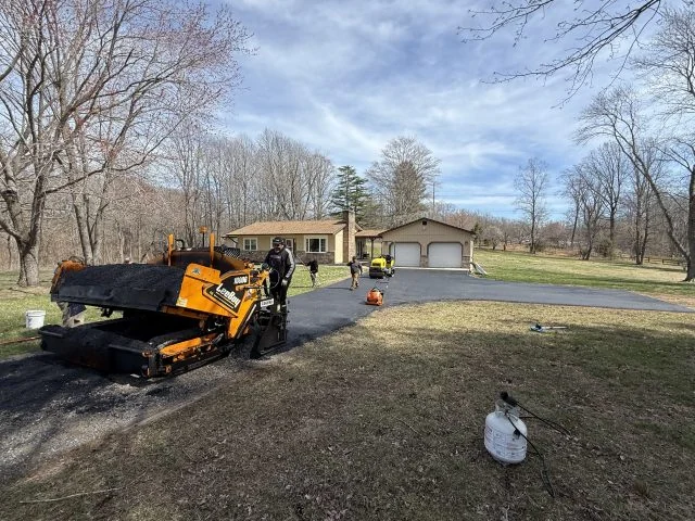 South State Paving paver working a long rural driveway