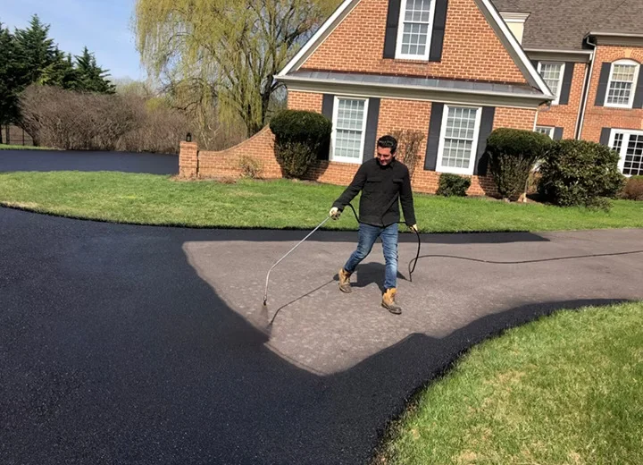 Sealcoat spray application on a residential driveway, South State Paving, Southern Maryland